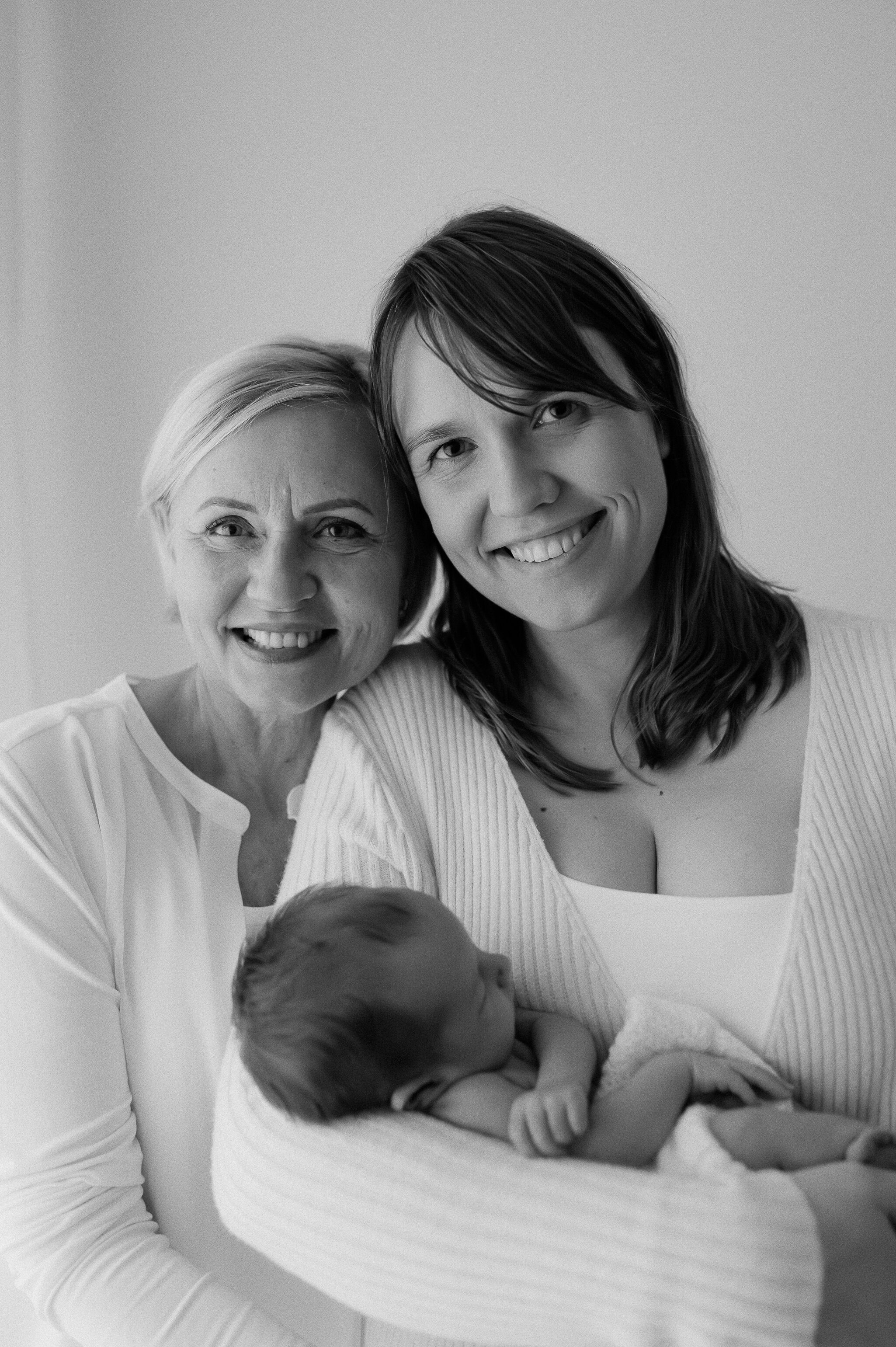 newborn baby girl behind held by Mum next to Grandma - three genarations captured by York photographer at studio in York near Leeds, Ripon and Harrogate