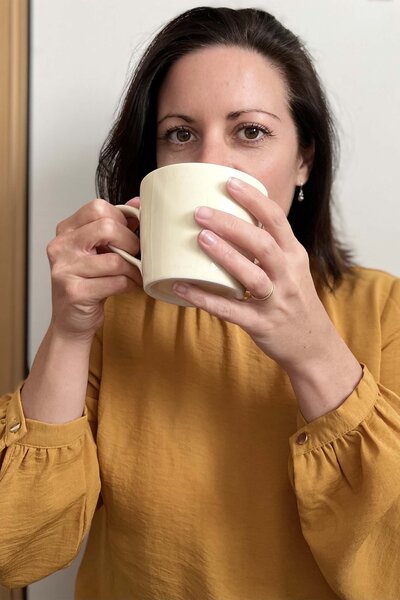 Photo of Caroline Kerhom-Nookala holding a cup of tea
