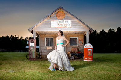 bride stands in front of the general store for a portrait at Hidden Acres in SC