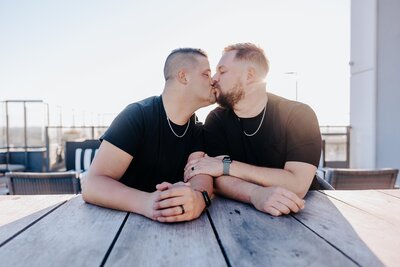 Nashville engagement photographer captures couple kissing at arcade during Nashville engagement photos