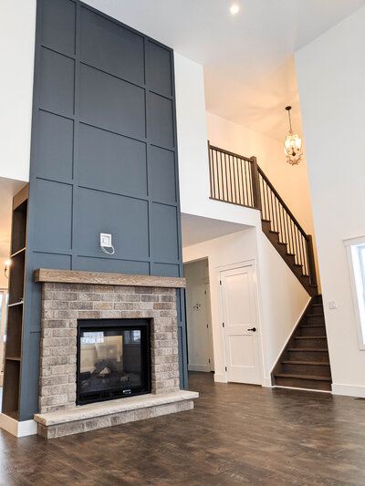 Fireplace wall with a railing to bedrooms