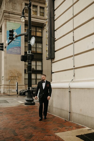 groom in wedding photo walking at belvedere wedding venue in baltimore maryland weddings
