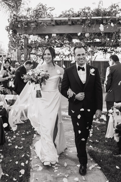 bride and groom waling down aisle after ceremony