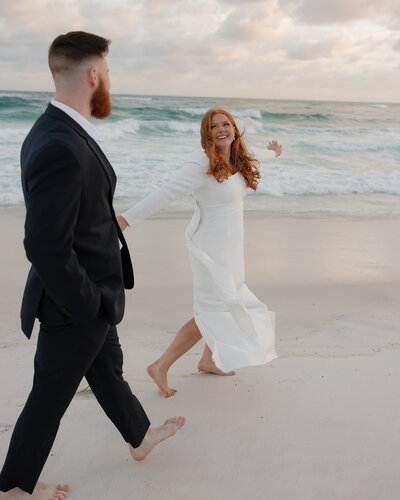 bride and groom run on 30A beach