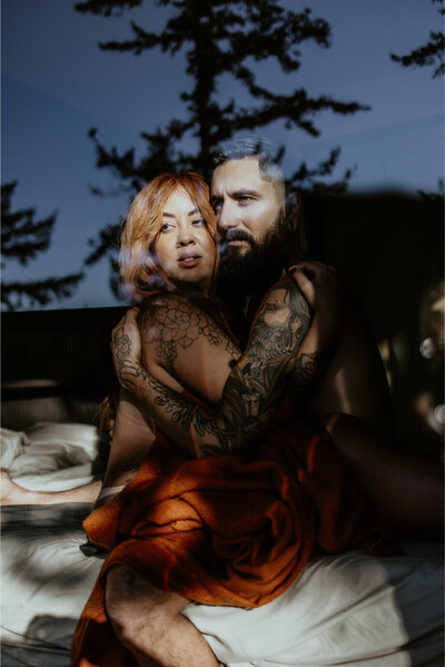 tattooed couple embracing