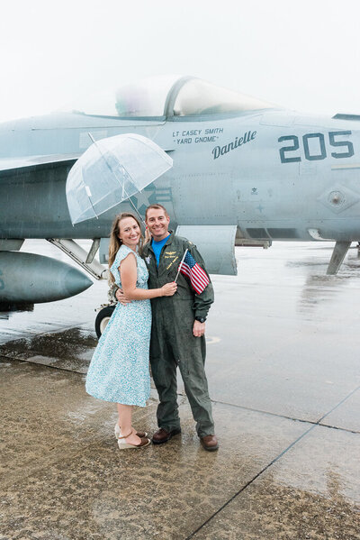photo of a  couple reuinted in front of a jet plane at a military homecoming in Virignia by Richmond photographer Jacqueline Aimee Portraits