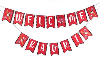 Ladybug baby shower banner with red flags and white writing