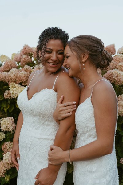 bride kissing with monarch butterfly on finger outside wedding venue upstate new york