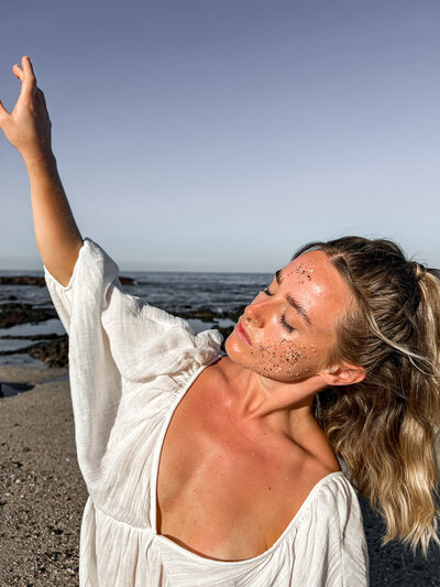 spiritual yoga woman on beach in white floating dress