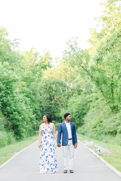 couple posing on a pathway in the woods during a gorgeous summer day at the Murfreesboro Greenway in Murfreesboro, TN