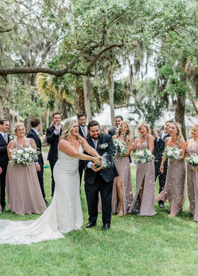 bride and groom popping champagne in st. augustine wedding