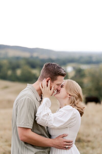 A couple goes in for a kiss during their engagement session in Northern Virginia