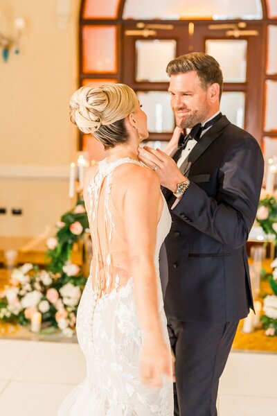 Bride and groom touching each others face