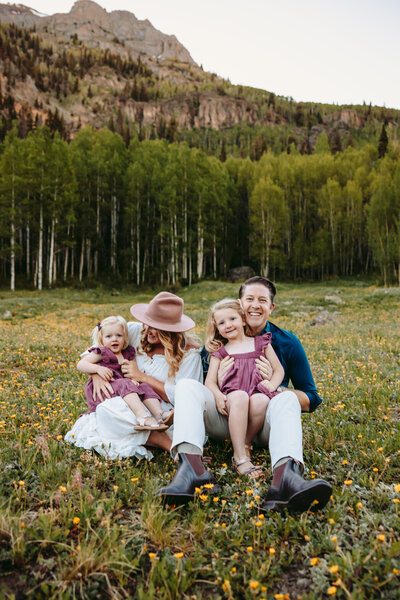 Family poses in wildflowers in Ouray, Colorado.