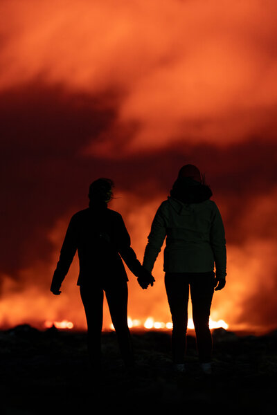 Couple standing in front of lava in Iceland