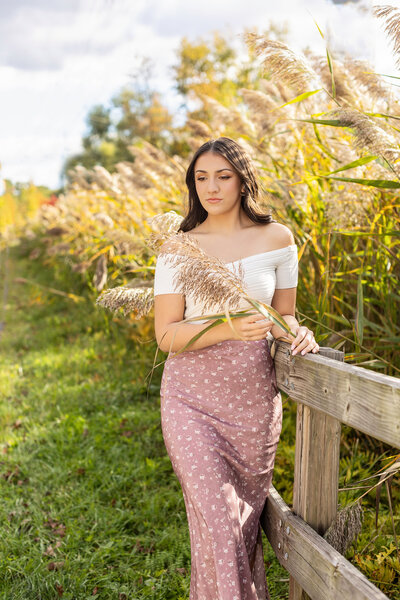 Senior girl in dress in a field