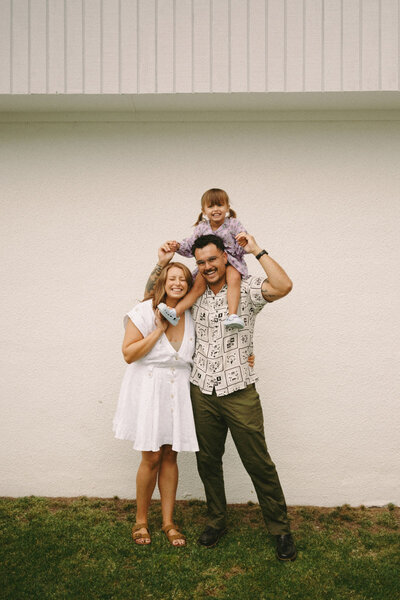A family portrait of a family playing on the beach in Auckland. Captured by Eilish Burt Photography