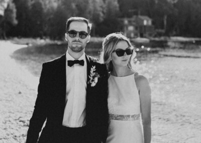 Bride and groom posing with sunglasses on