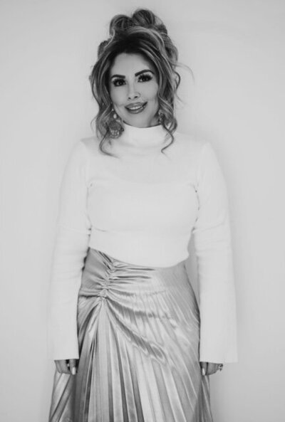 Kimberly, a realtor at Capital Realty, posing confidently in a professional portrait.