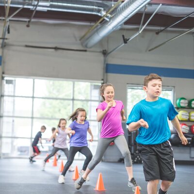 Kids participating in a fitness camp at Skopos Athletics in Dundas, MN, enjoy fun workouts designed to build strength, confidence, and athletic skills.