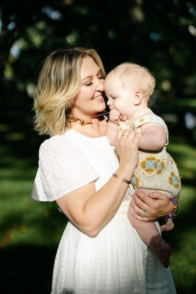 Family photography in Pearland, Texas with mom holding baby at the park – captured by Amy Marie Photography