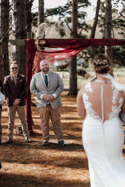 Nardus and Dehlia exchanging vows during their Auckland wedding ceremony, captured by Zanthe Vorsatz Photography.