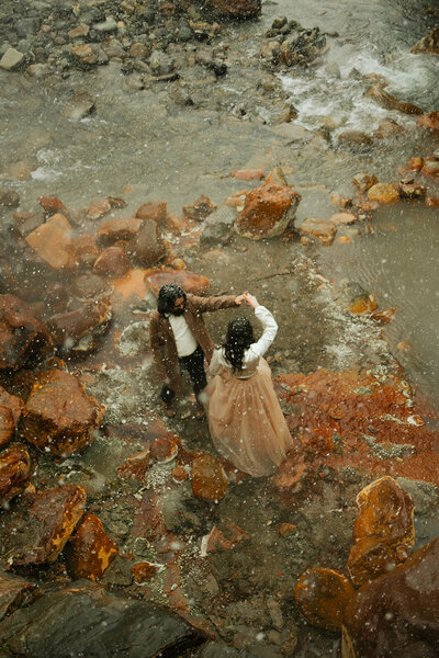 aerial shot of couple dancing in water