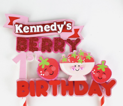 Bright red strawberry cake topper for first birthday