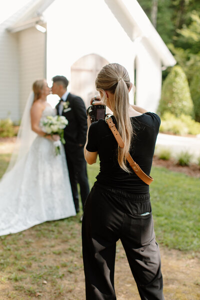 photographer taking a photo of newlyweds