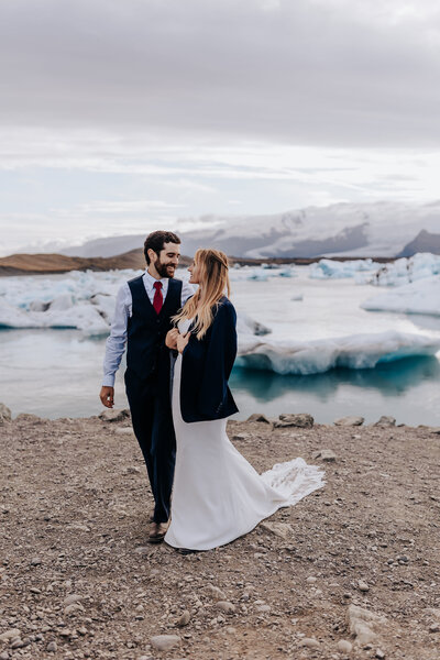 Iceland Wedding Photographer captures couple walking on beach during Iceland wedding