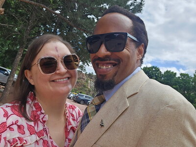 Ijah suit Michelle Dress sunglasses smiling