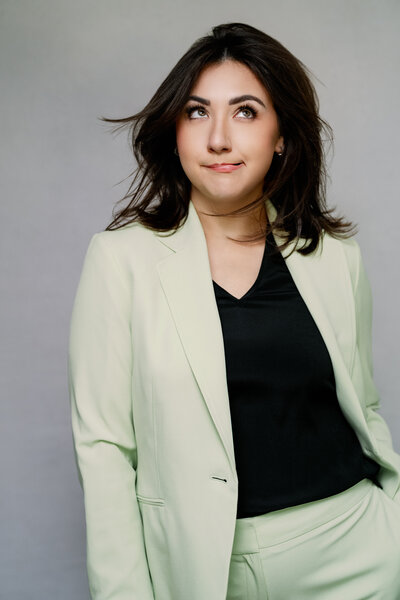 Alex Blair, founder of Alex Blair Wedding Photography, posing in a fun and playful photoshoot, wearing red cowboy boots.