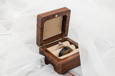 Photo of wedding rings in wooden ring box, captured by Aurora and Montgomery wedding photographer Kesha Wright
