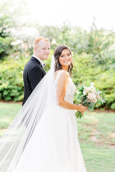bride and groom smiling  in Downtown Greenville