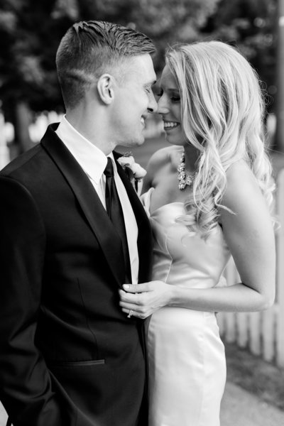 Bride and groom embrace in laughing pose