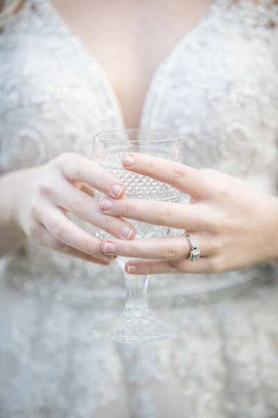 Closeup of bride holding a wine glass