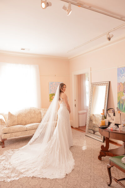 A bride and her bridesmaids get ready for a wedding in the bridal suite with Liriodendron Mansion wedding photographer