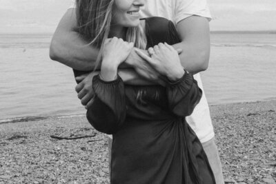 Couple embracing tenderly during a photoshoot in the Pacific Northwest, captured by Bare Bones Photo