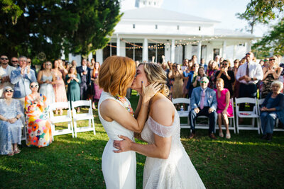Two Brides kissing during their Destination Wedding Ceremony in Alabama.