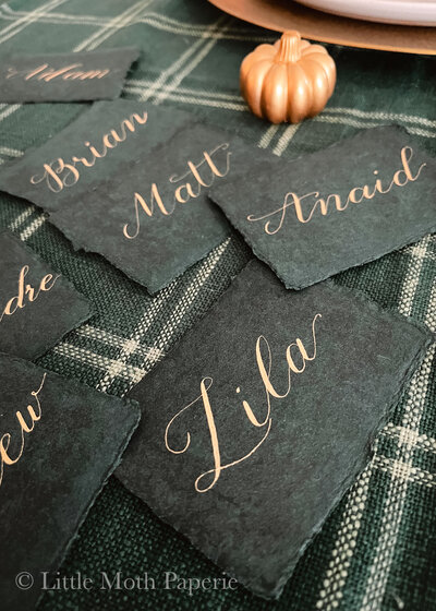 dusty blue wedding invitation with calligraphy and fun shape