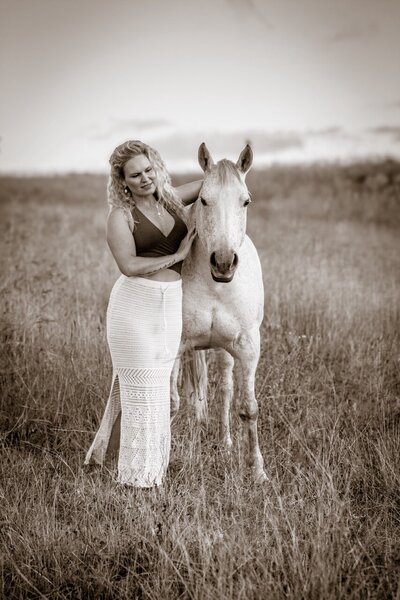 Woman in nature during a horse retreat in Australia, connecting through embodiment practices and somatic mentorship.