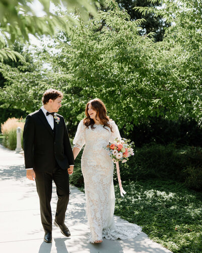 bride and groom walking and holding hands