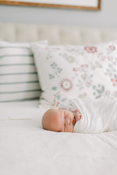 Newborn baby boy sleeping on a bed