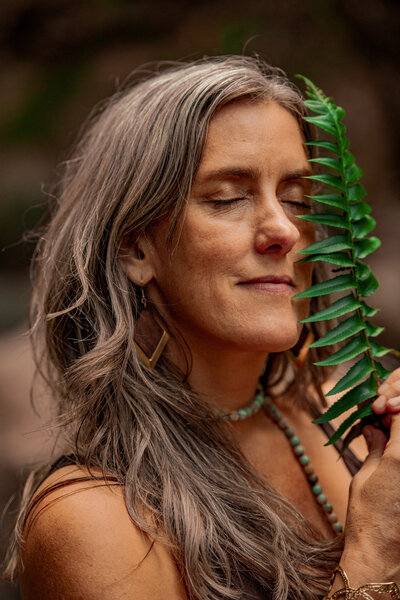 Woman meditating in nature during spiritual healing practice