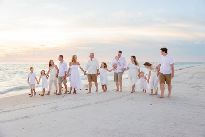 Extended Family photoshoot on Anna Maria Island at sunset with the ocean in the background.