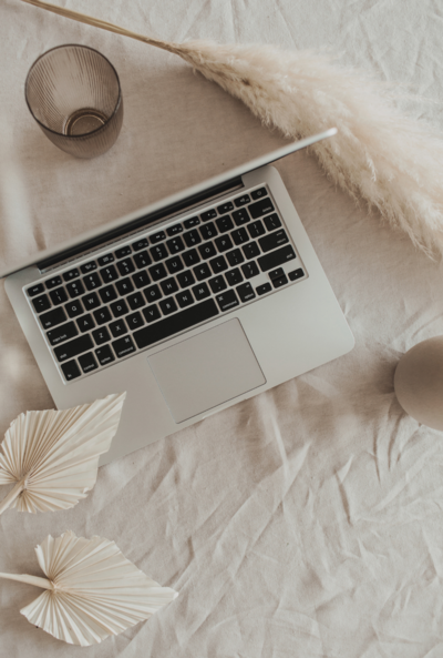 aesthetic flat lay shot of laptop computer in beige linen
