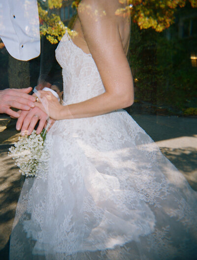 A short silky wedding dress hung up at a city hall elopement