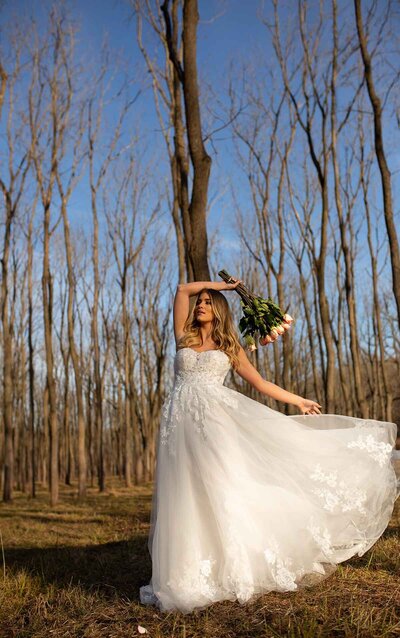 LACE WEDDING DRESS WITH FLARED SKIRT So very sparkly and undeniably sexy, this wedding dress by designer Stella York is simply a masterpiece! Layers of lace and tulle create a slim, modern fit-and-flare shape that flares out just below the hips for a dramatic finish. The full skirt comes with the option of matte tulle or sparkling sequin tulle for even more glamour. Deep, sheer side cutouts meet at an open back, which mirrors the plunging V-neckline. The layered floral lace fabrics create movement and drama throughout the bodice and cathedral-length train, which is finished with a magnificent full lace hemline. By adding beading throughout the gown, the subtle details of the lace shine and are given an extra pop! This stunning wedding dress zips up under buttons and is also available in plus sizes.