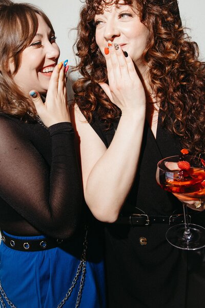 A person sitting on a dresser talking on a phone.