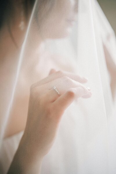 Bride standing gracefully under her veil, capturing a romantic and intimate moment on her wedding day in Columbus, Ohio.